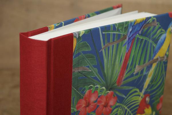 High-quality photo album with a red linen spine and a parrot motif